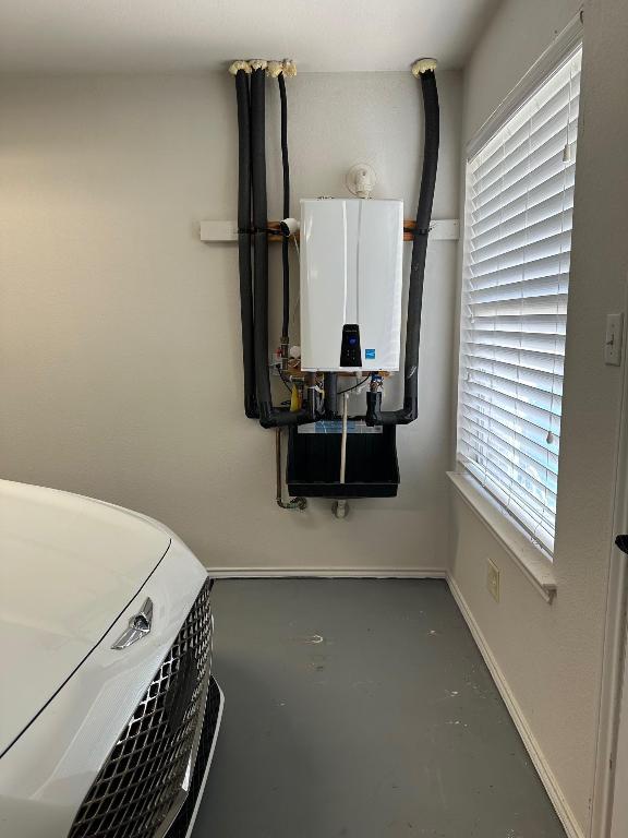 2520 Butler National Dr, Pflugerville, TX 78660 - laundry area featuring water heater and plenty of natural light