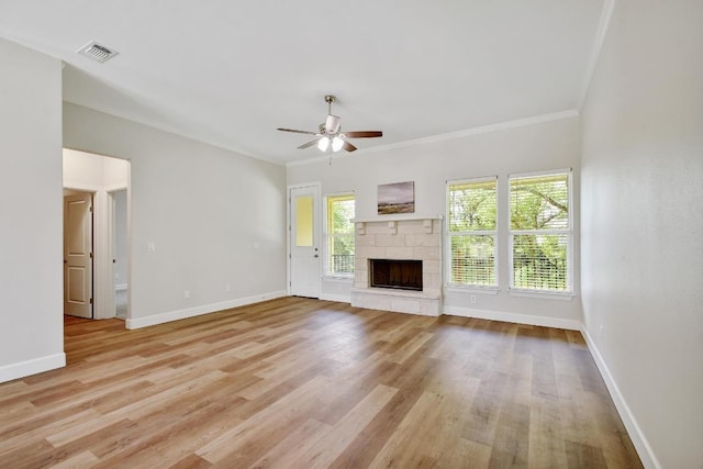 2109 Meadow View Dr, San Marcos, TX 78666 - unfurnished living room featuring ceiling fan, light wood finished floors, healthy amount of natural light, and crown molding