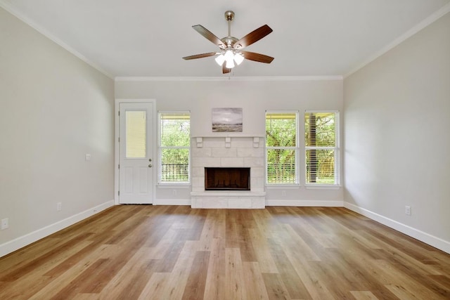 2109 Meadow View Dr, San Marcos, TX 78666 - unfurnished living room with a fireplace with raised hearth, crown molding, a ceiling fan, and wood finished floors