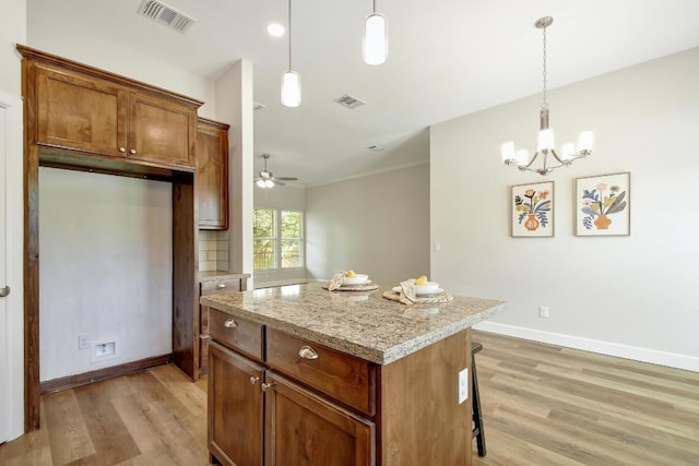 2109 Meadow View Dr, San Marcos, TX 78666 - kitchen with light wood finished floors, a kitchen island, pendant lighting, and ceiling fan