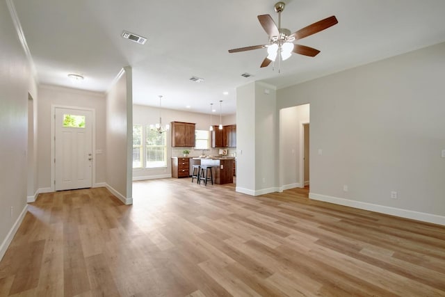 2109 Meadow View Dr, San Marcos, TX 78666 - unfurnished living room featuring light wood-style flooring, ceiling fan, and ornamental molding