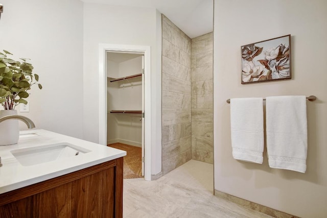 2109 Meadow View Dr, San Marcos, TX 78666 - full bathroom featuring tiled shower, double vanity, and a walk in closet