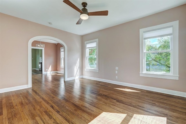 4412 Red River St, Austin, TX 78751 - unfurnished room with arched walkways, wood finished floors, ceiling fan, a smoke detector, and a chandelier
