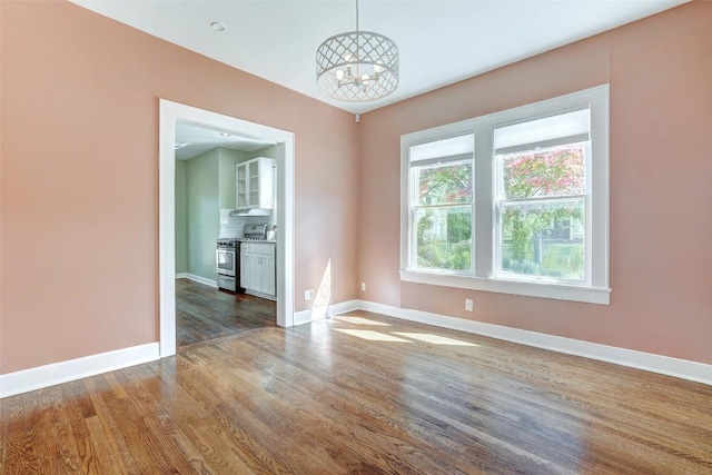 4412 Red River St, Austin, TX 78751 - unfurnished room with a chandelier and wood finished floors