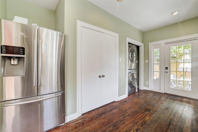 4412 Red River St, Austin, TX 78751 - kitchen featuring stainless steel fridge, stacked washer / dryer, and dark wood-type flooring