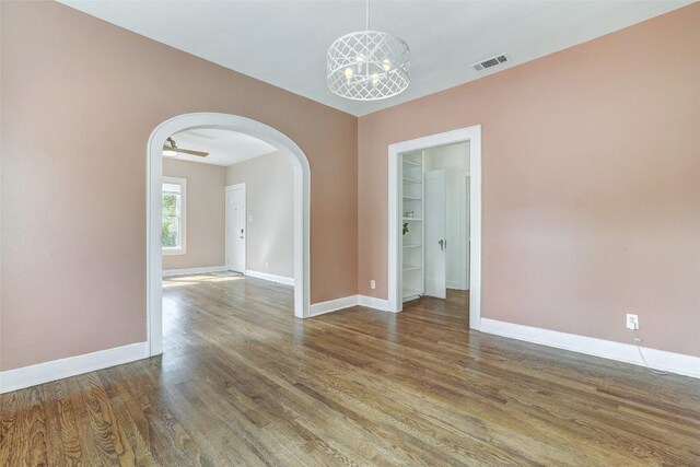 4412 Red River St, Austin, TX 78751 - spare room featuring arched walkways and wood finished floors