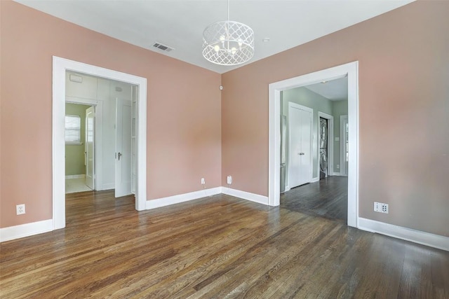 4412 Red River St, Austin, TX 78751 - unfurnished room featuring a chandelier and dark wood finished floors
