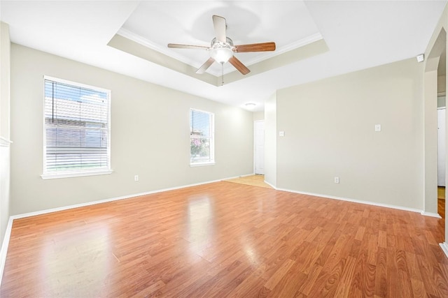 311 Carol Ave, Leander, TX 78641 - unfurnished room featuring a raised ceiling, healthy amount of natural light, light wood-type flooring, a ceiling fan, and ornamental molding
