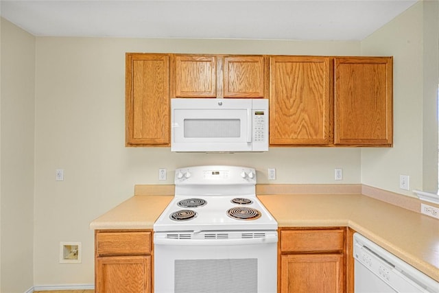 311 Carol Ave, Leander, TX 78641 - kitchen with white appliances, light countertops, and brown cabinets