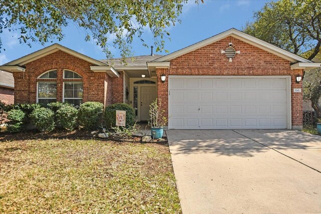 1141 Stone Forest Trl, Round Rock, TX 78681 - ranch-style home with brick siding, concrete driveway, a garage, and a front lawn