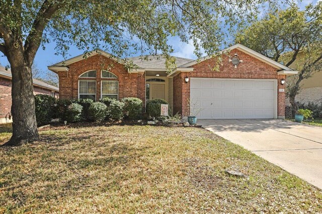 1141 Stone Forest Trl, Round Rock, TX 78681 - view of front of home featuring brick siding, a garage, driveway, and a front lawn