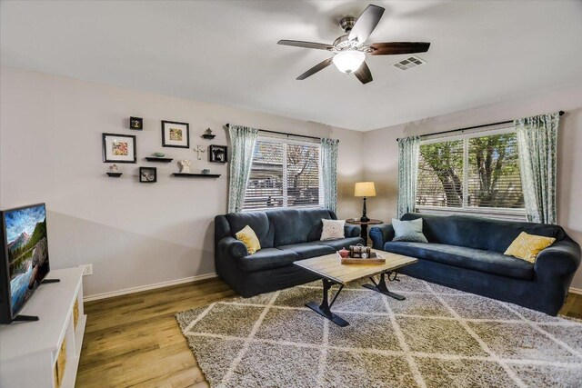 1141 Stone Forest Trl, Round Rock, TX 78681 - living area featuring wood finished floors, ceiling fan, and healthy amount of natural light