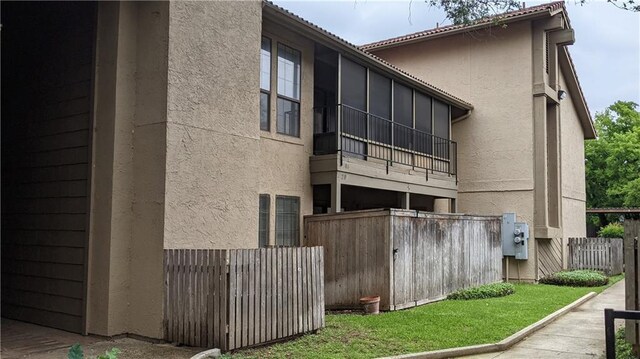 rear view of house featuring stucco siding