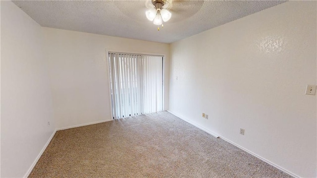 spare room featuring ceiling fan, a textured ceiling, and carpet flooring