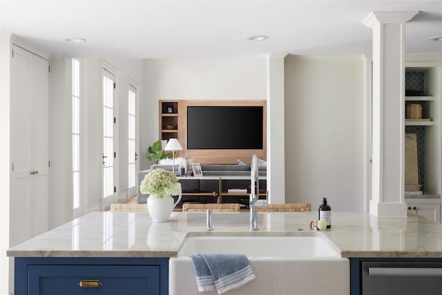 1904 Meadowbrook Dr, Austin, TX 78703 - kitchen featuring stainless steel dishwasher, light stone countertops, blue cabinetry, open floor plan, and recessed lighting