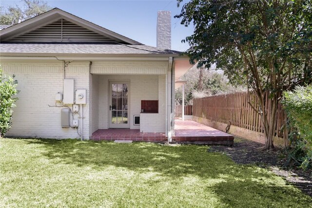 1904 Meadowbrook Dr, Austin, TX 78703 - rear view of house featuring brick siding, roof with shingles, and a chimney