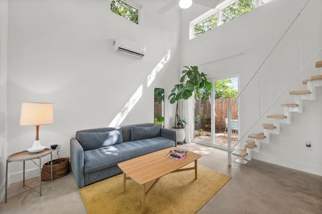 4706 Louis Ave, Austin, TX 78721 - living area with a wall mounted air conditioner, stairway, plenty of natural light, concrete floors, and a high ceiling