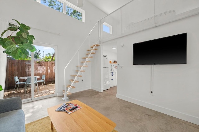 4706 Louis Ave, Austin, TX 78721 - living area featuring stairway, plenty of natural light, and a high ceiling