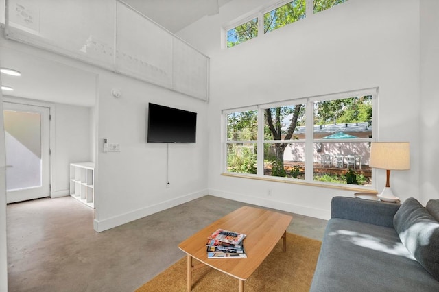 4706 Louis Ave, Austin, TX 78721 - living room with a towering ceiling and concrete flooring