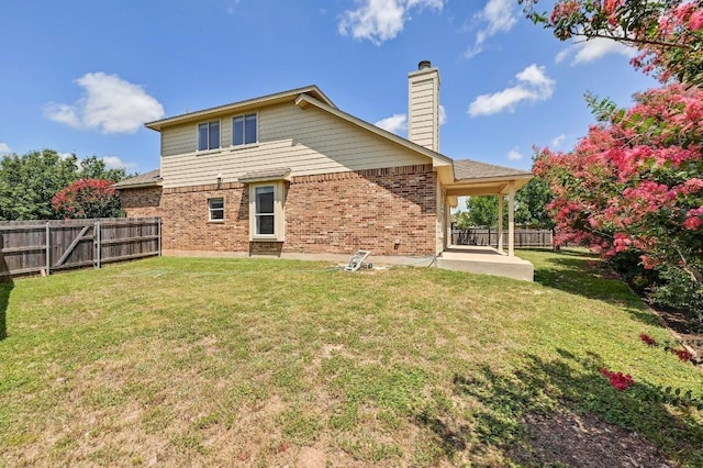 1921 Sand Creek Rd, Cedar Park, TX 78613 - rear view of house featuring brick siding, a patio area, a fenced backyard, and a chimney