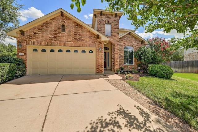 1921 Sand Creek Rd, Cedar Park, TX 78613 - traditional home featuring brick siding, a garage, and driveway