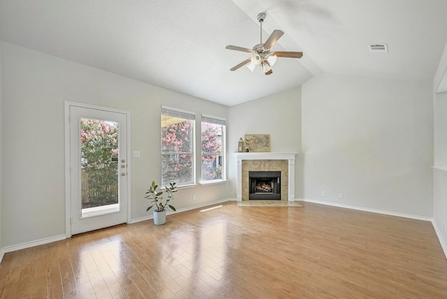 1921 Sand Creek Rd, Cedar Park, TX 78613 - unfurnished living room featuring a ceiling fan, lofted ceiling, light wood-type flooring, and a fireplace