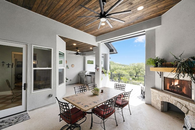 2250 Meritage, New Braunfels, TX 78132 - view of patio with a lit fireplace, a ceiling fan, area for grilling, and outdoor dining area