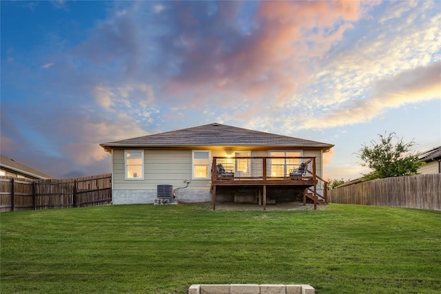 605 Liard River Rd, Hutto, TX 78634 - back of property at dusk with stairway, a deck, and a fenced backyard