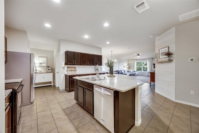 605 Liard River Rd, Hutto, TX 78634 - kitchen featuring electric stove, open floor plan, dishwasher, light tile patterned flooring, and an island with sink