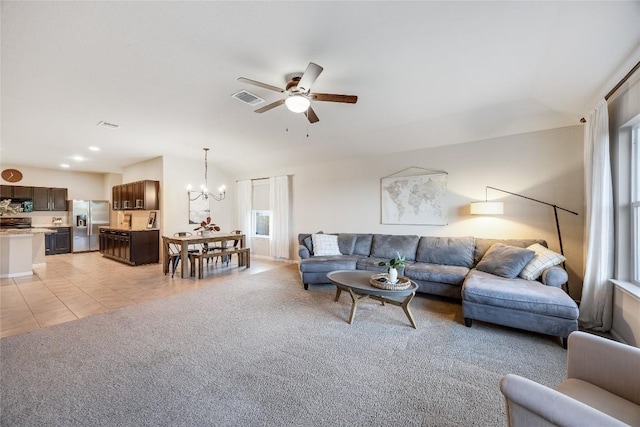 605 Liard River Rd, Hutto, TX 78634 - living room with a ceiling fan, a chandelier, light carpet, and light tile patterned flooring