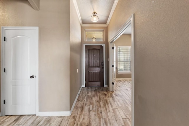 8305 Split Trail Cv, Temple, TX 76502 - foyer featuring light wood-type flooring, ornamental molding, and a textured wall