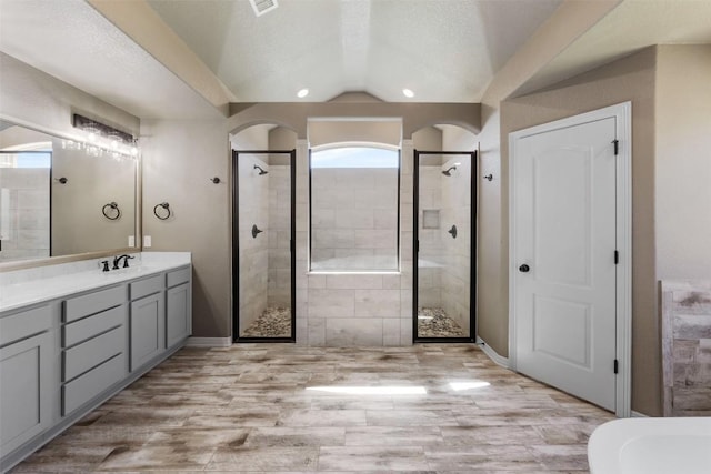 8305 Split Trail Cv, Temple, TX 76502 - bathroom featuring a shower stall, vanity, vaulted ceiling, a freestanding bath, and wood finished floors