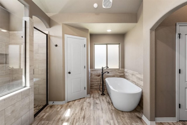 8305 Split Trail Cv, Temple, TX 76502 - full bath with a stall shower, a freestanding tub, wood finished floors, and tile walls