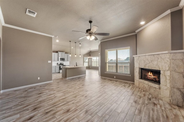 8305 Split Trail Cv, Temple, TX 76502 - unfurnished living room with ornamental molding, a textured ceiling, ceiling fan, light wood-style floors, and a fireplace