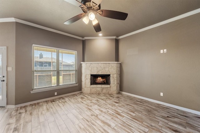 8305 Split Trail Cv, Temple, TX 76502 - unfurnished living room with wood finished floors, a stone fireplace, ceiling fan, ornamental molding, and a textured ceiling