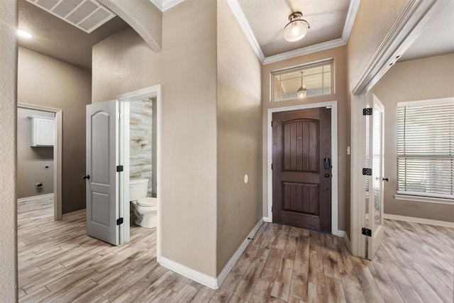8305 Split Trail Cv, Temple, TX 76502 - entrance foyer featuring light wood-type flooring, crown molding, a high ceiling, and arched walkways