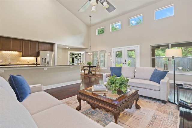 4104 Honeycomb Rock Cir, Austin, TX 78731 - living area with french doors, wood finished floors, a ceiling fan, and high vaulted ceiling