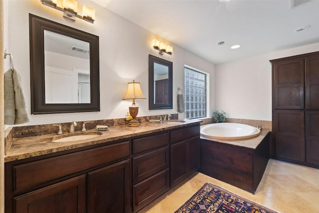 4104 Honeycomb Rock Cir, Austin, TX 78731 - full bathroom featuring double vanity, a garden tub, tile patterned floors, and recessed lighting