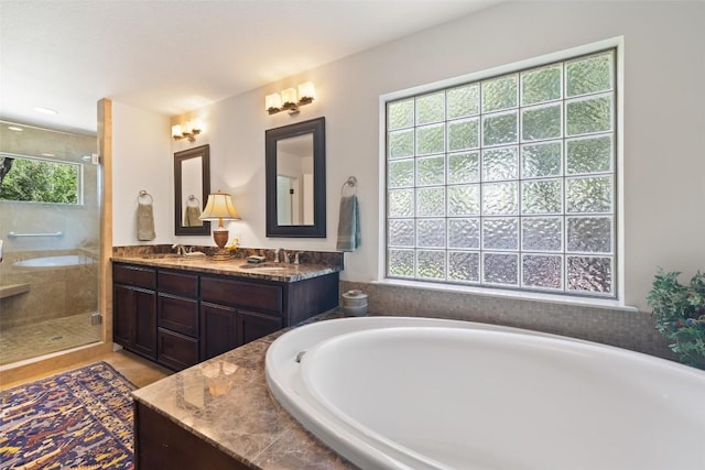 4104 Honeycomb Rock Cir, Austin, TX 78731 - bathroom featuring a bathtub, double vanity, and a shower stall