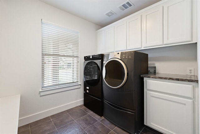 4104 Honeycomb Rock Cir, Austin, TX 78731 - laundry room featuring washing machine and dryer, cabinet space, and dark tile patterned flooring