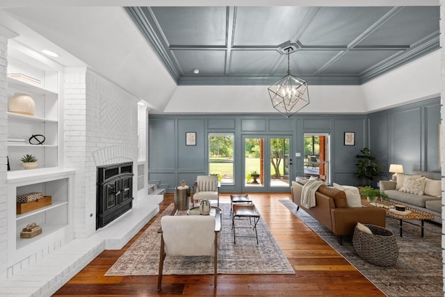 3501 Lost Pine Cv, Austin, TX 78739 - living room with a decorative wall, built in features, a fireplace, wood-type flooring, and ornamental molding