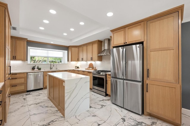 3501 Lost Pine Cv, Austin, TX 78739 - kitchen featuring appliances with stainless steel finishes, wall chimney exhaust hood, recessed lighting, light marble finish floors, and a kitchen island