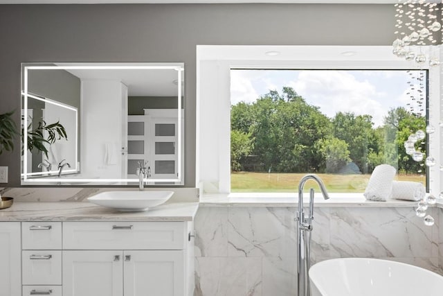 3501 Lost Pine Cv, Austin, TX 78739 - bathroom featuring vanity, a freestanding bath, and tile walls