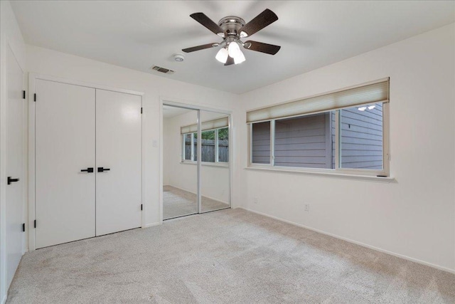 8432 Antero Dr, Austin, TX 78759 - unfurnished bedroom featuring multiple closets, carpet floors, and a ceiling fan