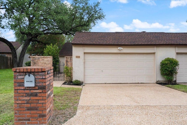 8432 Antero Dr, Austin, TX 78759 - garage featuring driveway and a gate