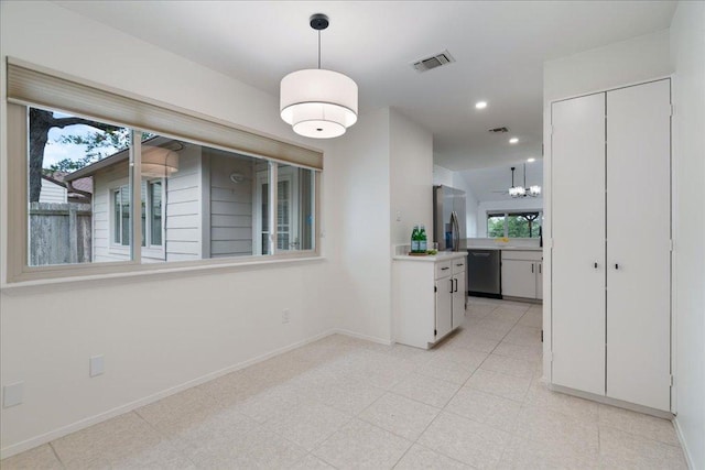 8432 Antero Dr, Austin, TX 78759 - unfurnished dining area with plenty of natural light, recessed lighting, and a chandelier