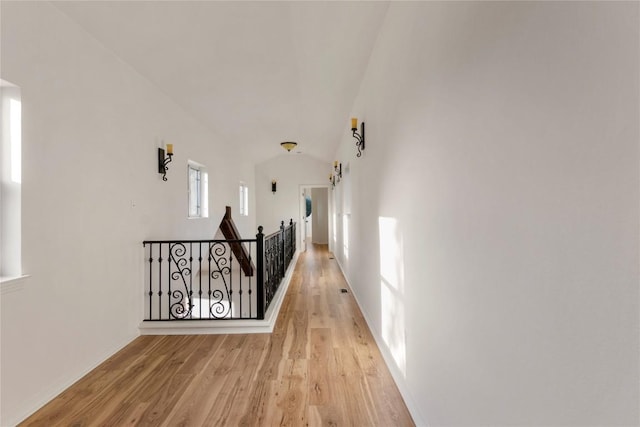 790 Enchanted Oaks Dr, Driftwood, TX 78619 - hall with an upstairs landing, light wood-style flooring, and vaulted ceiling
