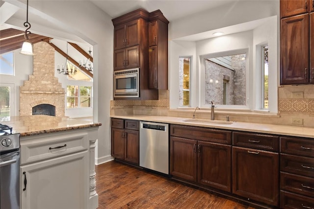790 Enchanted Oaks Dr, Driftwood, TX 78619 - kitchen featuring stainless steel appliances, plenty of natural light, decorative backsplash, and dark wood-type flooring
