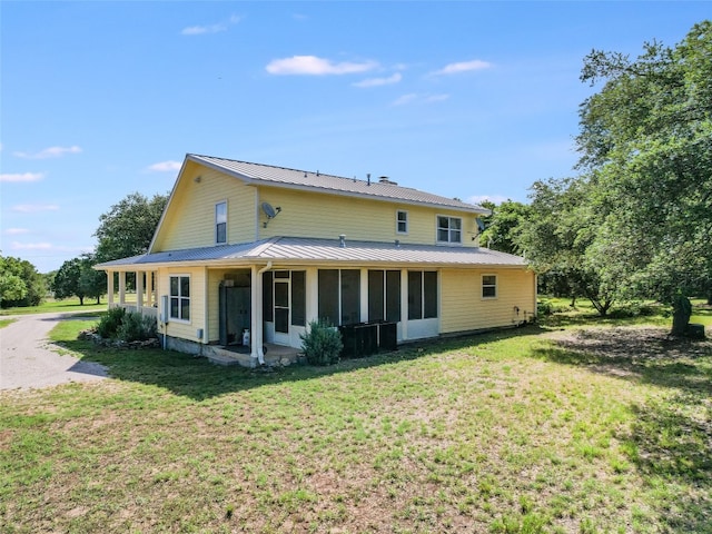 900 Crk 282, Liberty Hill, TX 78642 - back of property featuring a metal roof, a yard, and a sunroom
