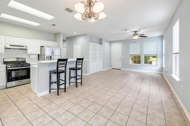 113 Stetson Trl, Georgetown, TX 78633 - kitchen with appliances with stainless steel finishes, ventilation hood, light countertops, light tile patterned floors, and white cabinetry